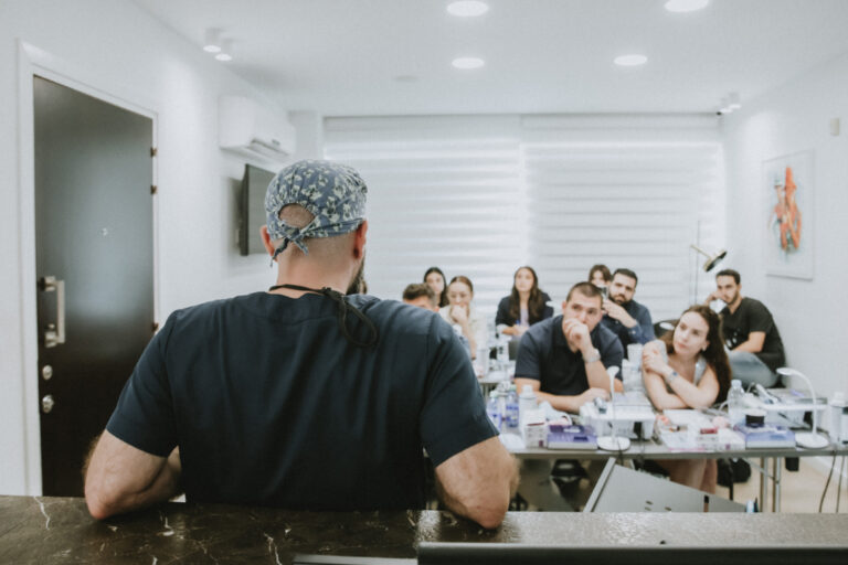 Instructor teaching students in a classroom setting.