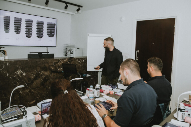 Instructor teaching dental implant course to students.